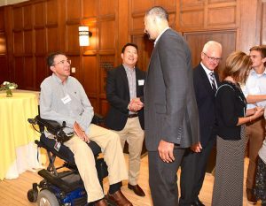 Photo of Juwan Howard, Bob Shoeni and Dr. Philip Choi