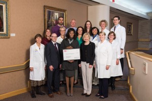 Paul Morning of the ALS Association Michigan presents a check to the University of Michigan Comprehensive ALS Clinic team.